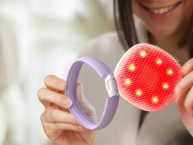 A woman opening FLIP™ play Advanced LED Light Hairbrush